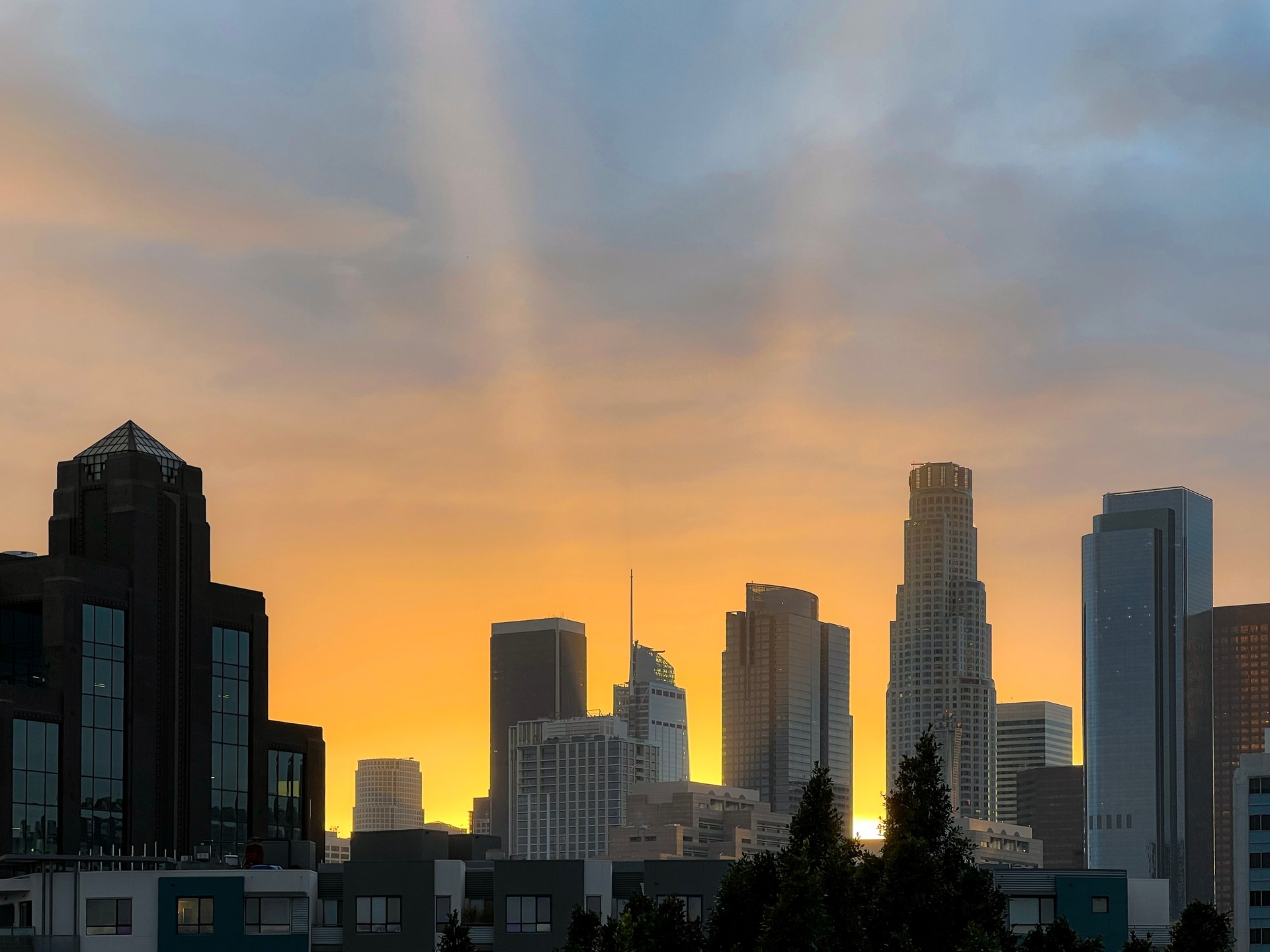 Radiant Light Beams from a Beautiful Sunset Behind Downtown Los Angeles Skyscrapers